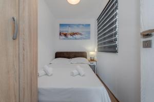 Postel nebo postele na pokoji v ubytování Apartmani Zaja