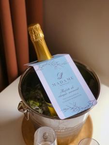 a bottle of champagne in a bucket on a table at Madame L & SPA in Svetlogorsk
