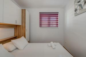 Postel nebo postele na pokoji v ubytování Apartmani Zaja