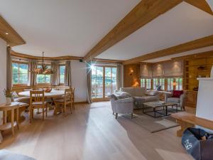 a living room with a table and chairs and a dining room at The 80 by Apartment Managers in Jochberg