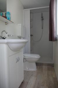 a bathroom with a toilet and a sink and a shower at Happy Camp mobile homes in Camping Villaggio Lamaforca in Carovigno