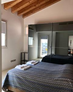 a bedroom with a bed with two towels on it at PORTOPICCOLO sul Mare Sistiana in Sistiana