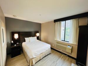 a bedroom with a large bed and a window at Rockaway Hotel in Brooklyn