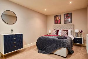 a bedroom with a bed and a mirror and a dresser at The Exquisite Harrogate Abode - Sleeps 6 in Harrogate