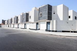 a row of buildings on the side of a street at Mabaat - White Pearl Al Basatin - 600 in Jeddah
