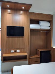 a room with a bed and a tv and a room with a bed sidx sidx at Collina Hotel in Camapuã +18 photos