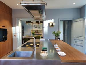 a kitchen with a sink and a wooden counter top at CHATEAU DE BRINVILLE in Saint-Sauveur-sur-École