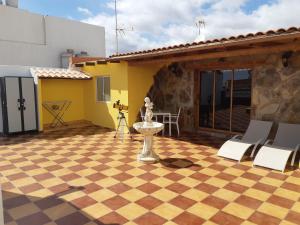 a patio with a checkered floor in front of a house at Casa Guanche in Cruce de Arinaga