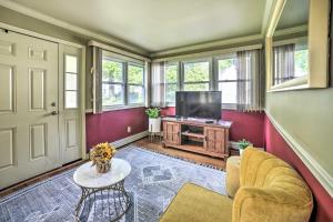 a living room with a tv and a couch and a table at Pet-Friendly Latham Retreat about 7 Mi to Albany! in Latham