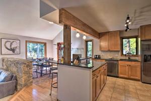 a kitchen with a counter top and a living room at Cozy Blue River Cabin with Treehouse 6 Mi to Skiing in Blue River