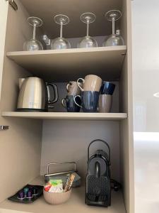a pantry with shelves filled with pots and pans at Queen Verona Luxury Apartment in Verona