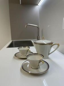 a kitchen counter with two tea cups and a sink at Queen Verona Luxury Apartment in Verona