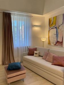 a living room with a couch and a window at Queen Verona Luxury Apartment in Verona +27 photos