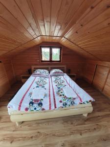 a bed in a small room in a cabin at Domek pod Królowem in Ustroń +36 photos
