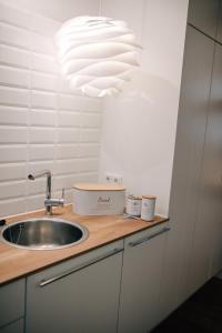 a kitchen with a sink and a large light fixture at Ferienwohnung DOMizil Bamberg in Bamberg