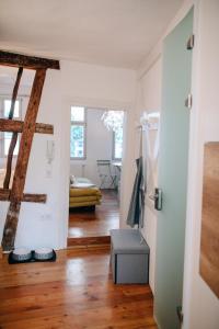ein Wohnzimmer mit weißen Wänden und Holzböden in der Unterkunft Ferienwohnung DOMizil Bamberg in Bamberg