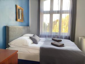 a bedroom with a bed with two towels on it at Kamienica Monte Cassino Sun I 7 min plaża I 2 sypialnie I Balkon in Sopot +4 photos