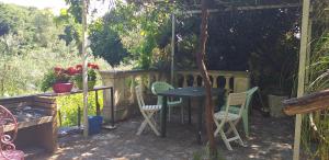 un patio con una pérgola con mesa y sillas en L'ANGOLINO, Casale vita nova, en Manciano