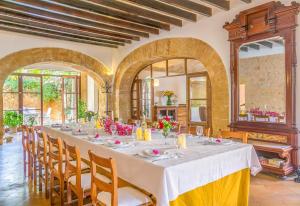 a large dining room with a long table and chairs at Historica house with Pool free wifi in Andratx