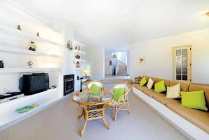 a living room with a couch and a tv at Casa do Alvor in Alvor