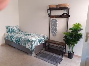 a bedroom with a bed and a table and a plant at VILLA ZRMANJA - 3 appartementen in Obrovac