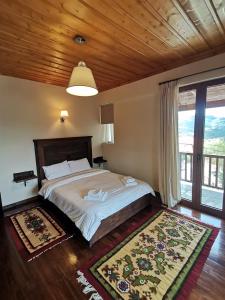 a bedroom with a bed and a large window at Panorama Vytinas in Vytina