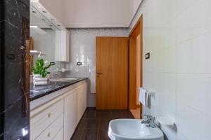 a bathroom with two sinks and a toilet at Villa Cielo e Terra by BarbarHouse in Torre Suda