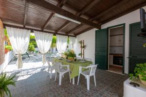 an outdoor patio with a table and chairs at Villa Cielo e Terra by BarbarHouse in Torre Suda