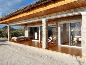 a house with a wooden deck and glass doors at Ankasy Lodge in Tsifota