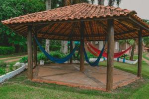 a gazebo with two hammocks in a park at Panorama Park Hotel in Igarassú