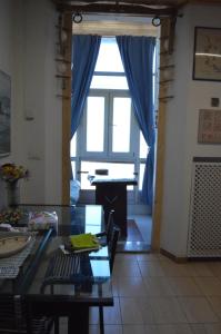 a living room with a table and a large window at Stefi Appartamento, Camera in Falconara Marittima