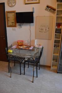 a table with a glass top in a room at Stefi Appartamento, Camera in Falconara Marittima