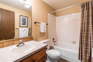 a bathroom with a sink and a toilet and a tub at Trapper 8 in West Yellowstone