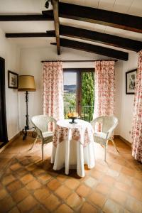 a dining room with a table and chairs and a window at Finca Rural Son Rabassa in Sant Joan