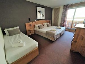 Voodi või voodid majutusasutuse Hôtel Aalborg toas