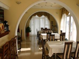 a dining room with tables and chairs in a restaurant at Apartments & Rooms Elite in Dobra Voda
