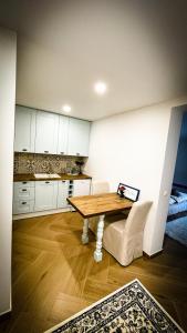 a kitchen with a wooden table and white cabinets at Casa Rural, Molí de les Pereres in Penáguila