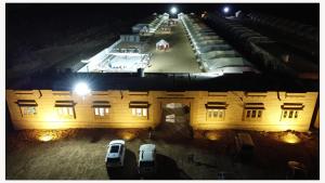 a building with cars parked in front of it at night at Jaisalmer Desert Resort in Jaisalmer