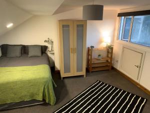 a bedroom with a bed and a desk and a window at Balham, South London Spacious Guest House 6 in London