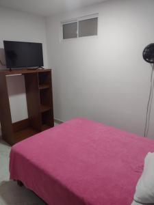 Rúm í herbergi á Hotel Risaralda