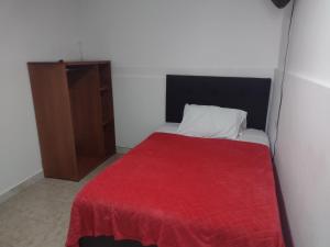 Rúm í herbergi á Hotel Risaralda