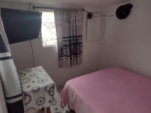 Rúm í herbergi á Hotel Risaralda