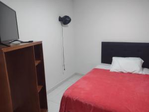Rúm í herbergi á Hotel Risaralda