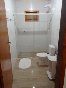 a small bathroom with a toilet and a sink at A Casa é Sua! in Urubici