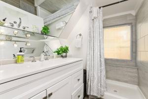 a white bathroom with a sink and a window at Surf View in Lincoln City