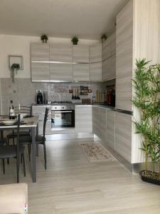 a kitchen with a table and a dining room at SUNSET SUITE in Capoliveri