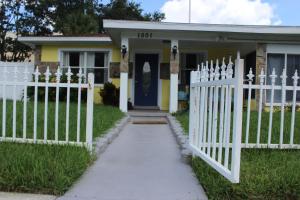 a white picket fence in front of a house at Traditional Cozy Historic Tampa Home in Tampa