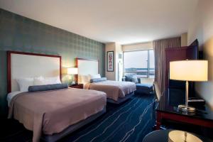 a hotel room with two beds and a window at Bally's Quad Cities Casino & Hotel in Rock Island