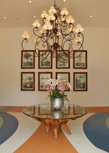 a glass table with a vase of flowers on it at Condominio Barretos Thermas Park - Condohotel in Barretos