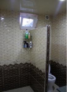 a bathroom with a shower with a toilet and a window at Armen's B&B in Sevan